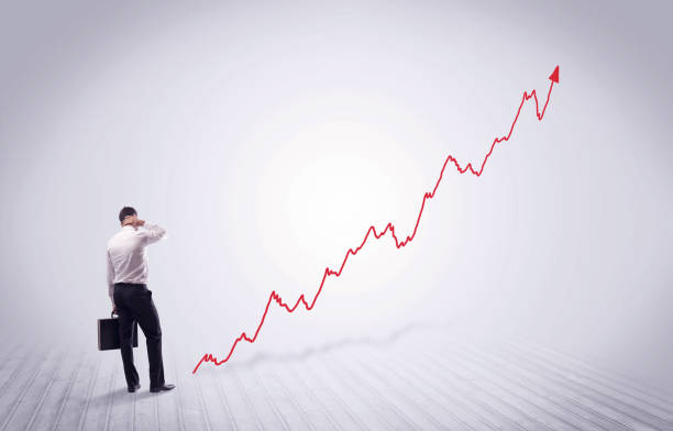 istock Standing businessman with red graph arrow 1163910887