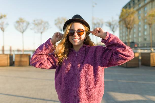 outdoor portrait of smiling teen girl 13, 14 years old - 12 13 years pre adolescent child female blond hair imagens e fotografias de stock