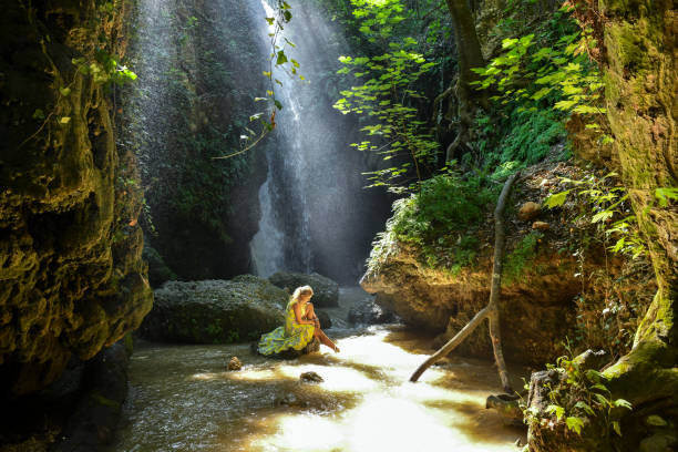 istock The woman at the waterfall. 1163911622