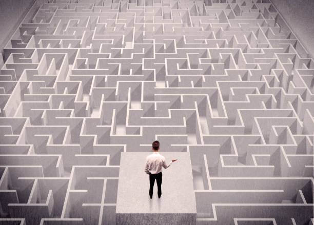 istock Businessman looking at labirynth from above 1163912229