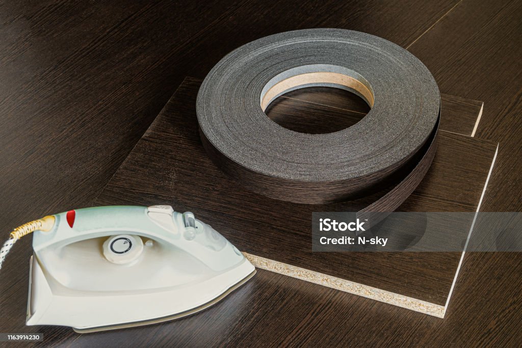 Roll Melamine Edge For Finishing Of Furniture And Smoothingiron Used For  Gluing Edges Edging Tape Lying On Laminated Chipboard Sheets Wenge Color  Stock Photo - Download Image Now - iStock