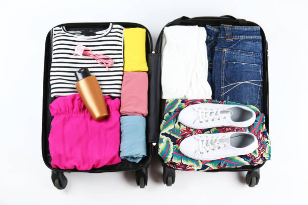 istock Plastic hardshell suitcase packed with casual clothing items. 1163914374