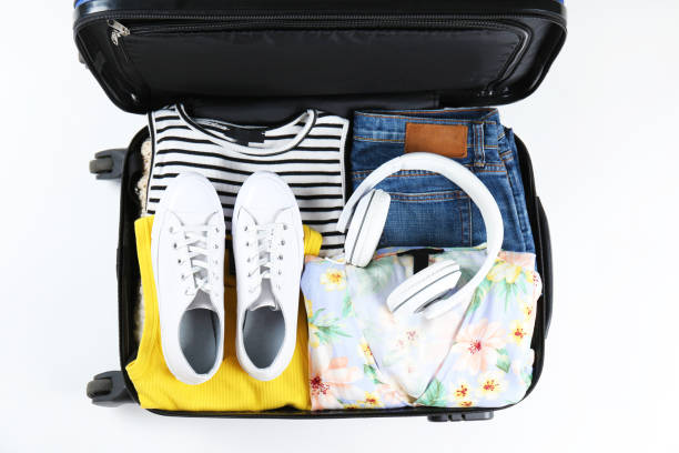 istock Plastic hardshell suitcase packed with casual clothing items. 1163914453