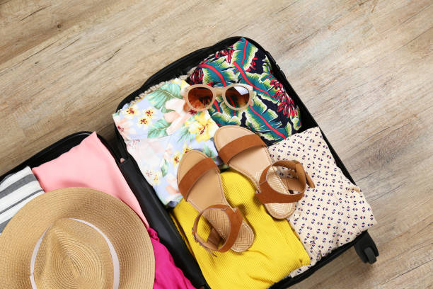 istock Plastic hardshell suitcase packed with casual clothing items. 1163915189