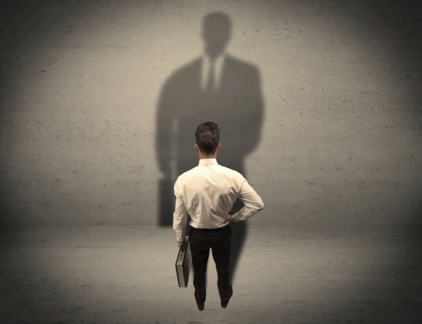 istock Businessman looking at big shadow concept 1163915198
