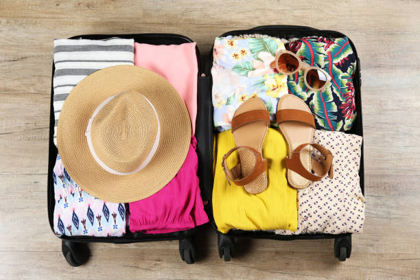 istock Plastic hardshell suitcase packed with casual clothing items. 1163915230