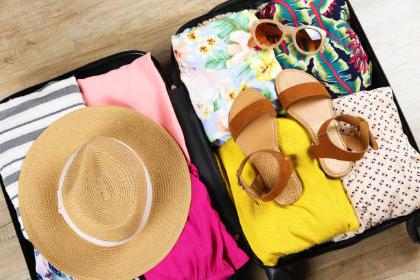 istock Plastic hardshell suitcase packed with casual clothing items. 1163915273