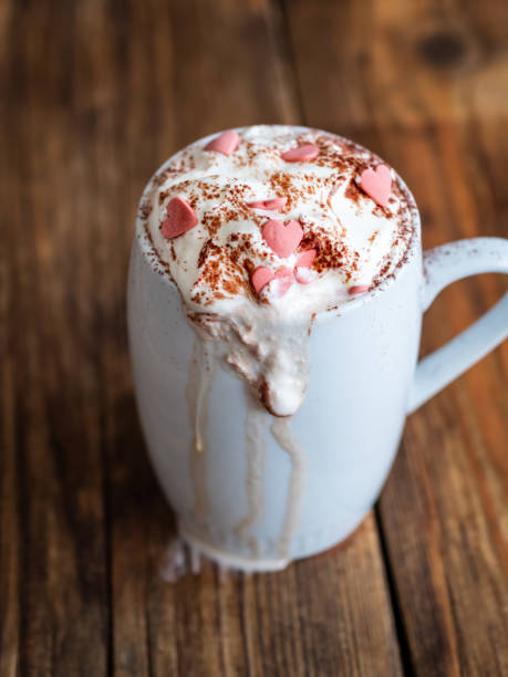 istock Hot chocolate with pink hearts in a white cup 1163915352