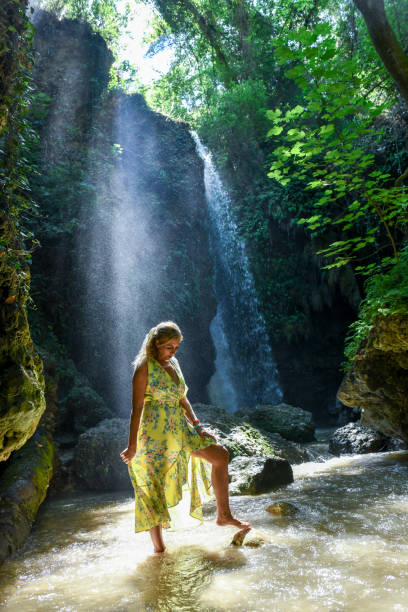 istock The woman at the waterfall. 1163915623