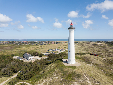 Hvide Sande, Denmark - July 10, 2019: Aerial drone view of Lyngvig Lighthouse at the Danish West Coast.