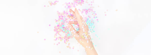 istock Pearl pastel confetti sparkles with woman hand 1163918231