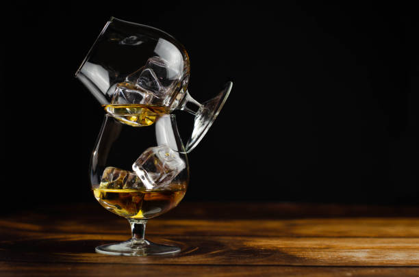 istock Two whiskey / cognac glasses with ice 1163918573