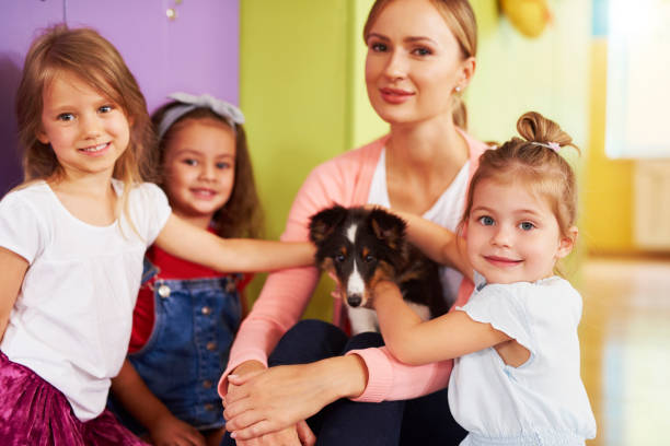 istock Preschool children having fun with dog 1163918657
