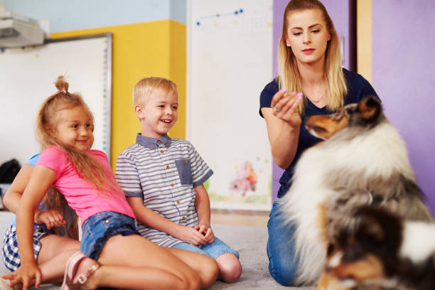 istock Happy kids with dog during therapy 1163919652
