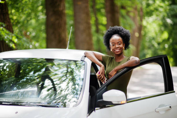 istock African american woman posed against white car 1163919976
