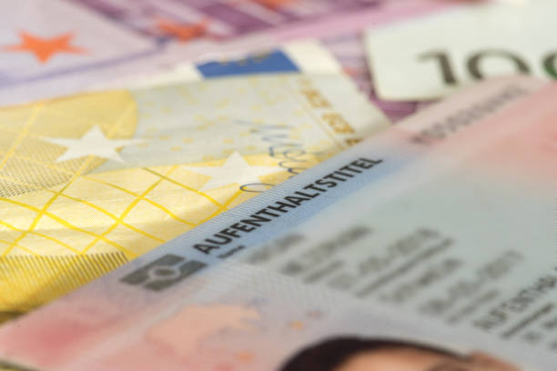 istock Euro banknotes and residence permit for Germany 1163920077