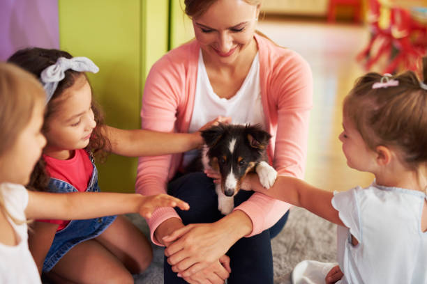istock Happy kids stroking cute dog 1163920107