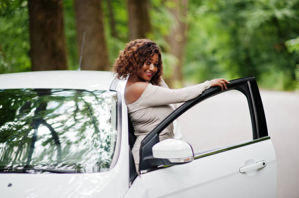 istock African american woman posed against white car 1163920271