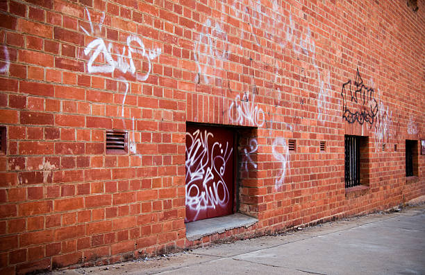 istock Grunge street scene with red brick wall and graffiti 116392102