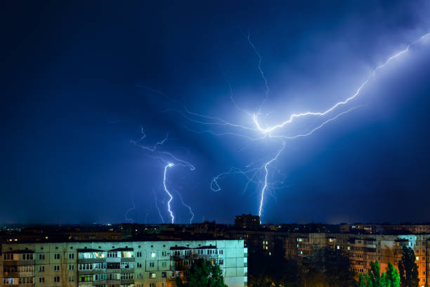 istock Thunderstorm with lightning and thunder over the night city 1163921110