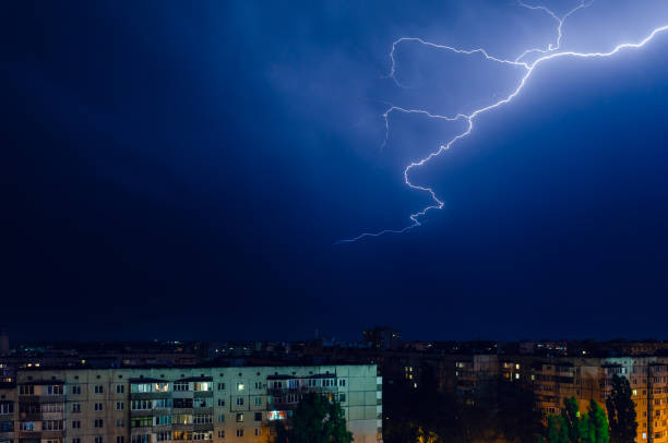 istock Thunderstorm with lightning and thunder over the night city 1163921114