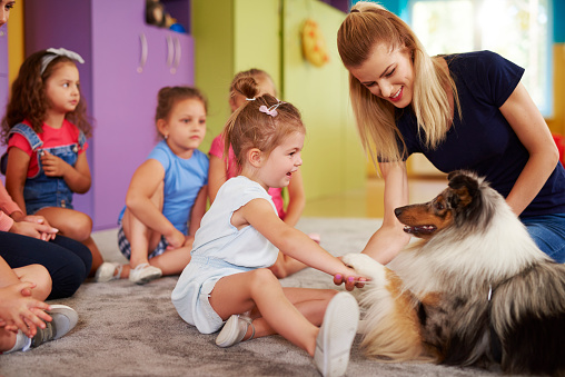 Happy child playing with dog