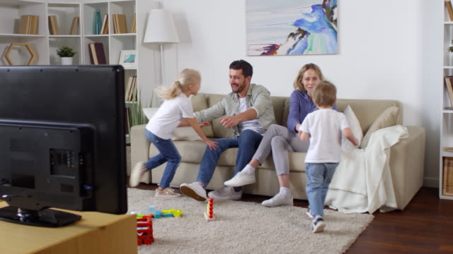 Adorable Family Watching TV