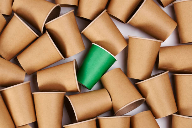 istock Green disposable mug among  paper mugs 1163924072