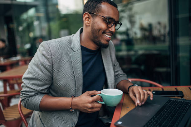 istock Handsome young man sitting in cafe 1163924315