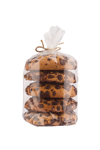 front view closeup of stack chocolate brown round cookies in transparent plastic packaging tied with rope isolated on white background