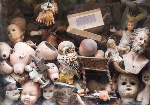 close up of puppet toy parts behind a shop window