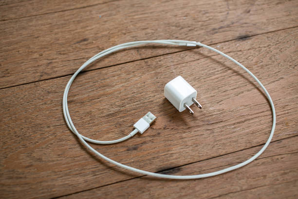 istock Smart Phone Charger Cable on wooden table background, Close up & Macro shot, Selective focus, Technology, Business concept 1163925666