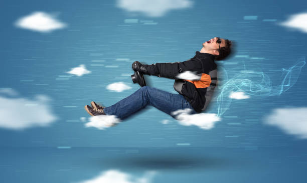 istock Funny racedriver young man driving between clouds concept 1163925668