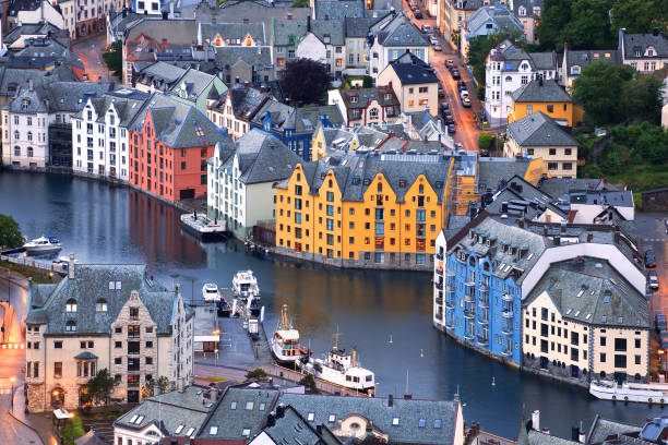 Alesund Norway harbor port with sailboats, colorful buildings, blue sky, summer tourism destination
