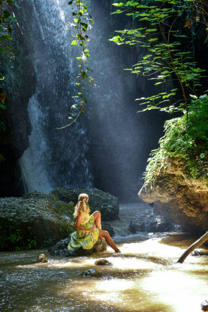istock The woman at the waterfall. 1163925934