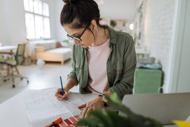 istock Young woman working in a modern office 1163926081