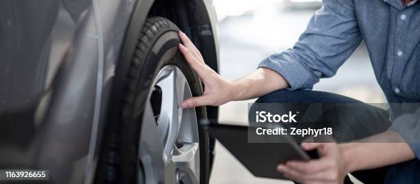 Auto Mechanic Checking The Car Using Tablet Stock Photo - Download Image Now - Car, Tire - Vehicle Part, Auto Repair Shop