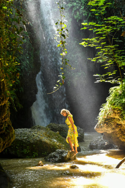 istock The woman at the waterfall. 1163926969
