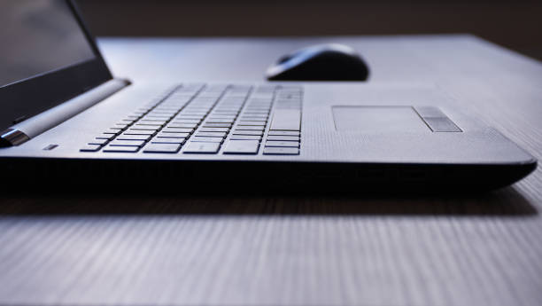 istock Laptop and computer mouse mouse on the office desk 1163927114