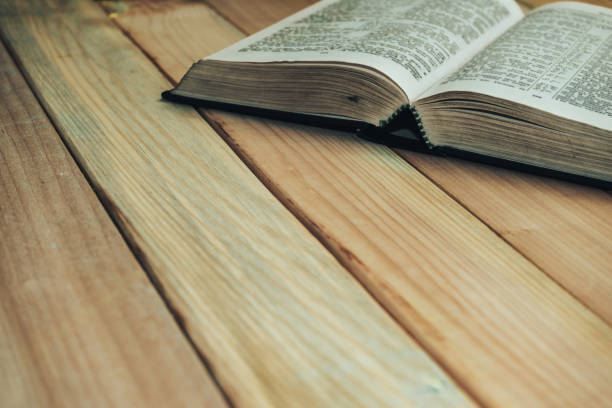 istock Close up open Bible book on a wooden table background. 1163928946