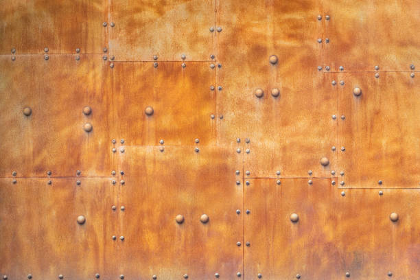 istock Rusty metal wall texture background. Rusty red wall of iron with rivets. 1163928950