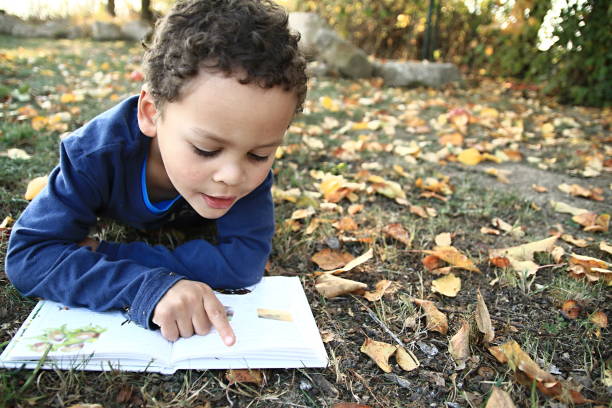 istock little boy with his school book back to school 1163930628