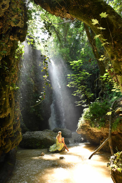istock The woman at the waterfall. 1163931913