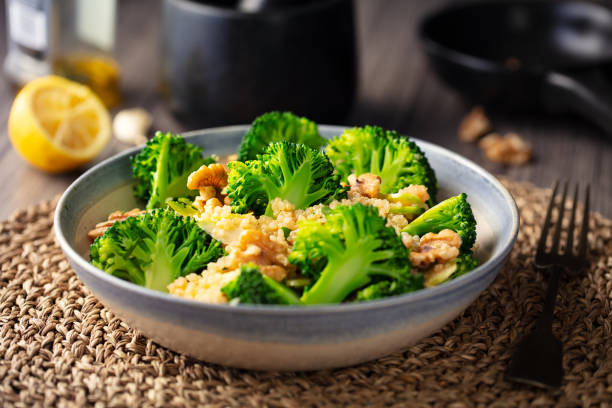 insalata di quinoa di broccoli sani con noci - healthy eating close up lemon nut foto e immagini stock
