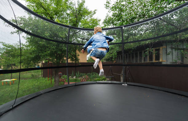 istock Little boy enjoys jumping on trampoline. 1163932176