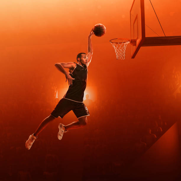 istock African american basketball player makes slam dunk 1163932390