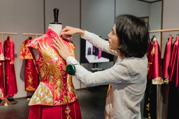 istock Chinese wedding dress designer working in his studio 1163932396