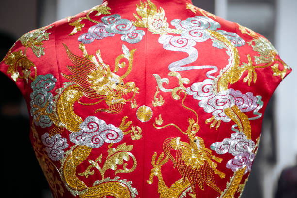 Back of traditional Chinese embroidered wedding dress Close-up back view of traditional Chinese wedding dress embroidered with symbolic dragon design. chinese wedding dress stock pictures, royalty-free photos & images