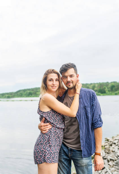istock Young romantic couple hugging near the lake. 1163933041