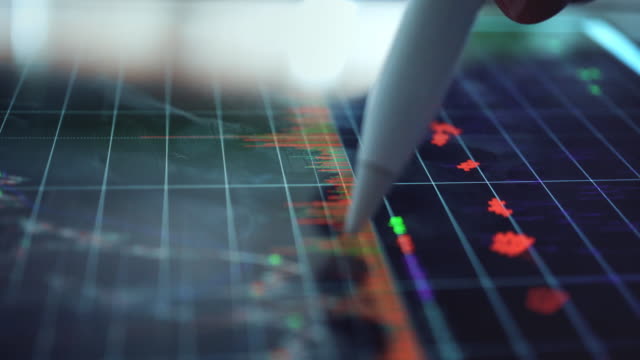 Businessman analyzing at graph of stock market data,Close-up